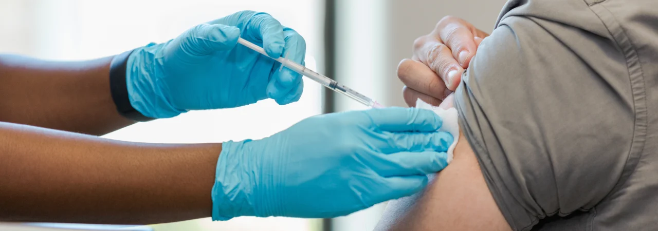 A patient receiving a shot in the arm.